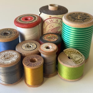 Selection of mixed wooden spools loaded with cotton & silk threads. Variegated greens, lime, gold, red, rust, blue, white, grey. Great mix!