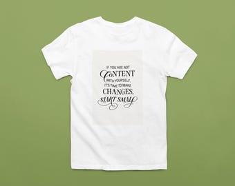 May include: White t-shirt featuring the quote "IF YOU ARE NOT CONTENT WITH YOURSELF, IT'S TIME TO MAKE CHANGES, START SMALL" in black script. The shirt is on a green background.