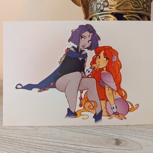 May include: A digital illustration of two women with long hair. The woman on the left has purple hair and is wearing a dark blue cape with red accents. The woman on the right has orange hair and is wearing a purple dress with gold accents.