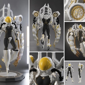 May include: A detailed figurine of a futuristic character in a black and white suit with a yellow helmet. The figure has elaborate white and gold accents, including wings and circular designs. It stands on a circular base.
