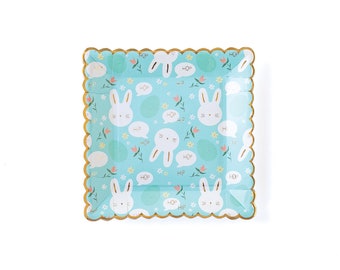 May include: Square blue paper plates with a gold scalloped edge and a repeating pattern of white bunnies, flowers, and the words "Hop" and "Hip".