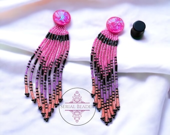 Indigenous beadwork neon pink dangle earrings your choice of black or pink covers for plugs.