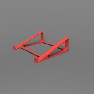 May include: A red laptop stand with a minimalist design. The stand is made of a solid material and features a rectangular base with angled supports. The stand is designed to elevate a laptop for improved ergonomics and airflow.