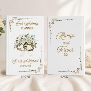 May include: Two white hardcover wedding planners with gold foil text and floral accents. The front cover reads Our Wedding Planner, Sarah & Michael, 06.08.2026. The back cover reads Always and Forever. Both feature gold decorative corner borders.