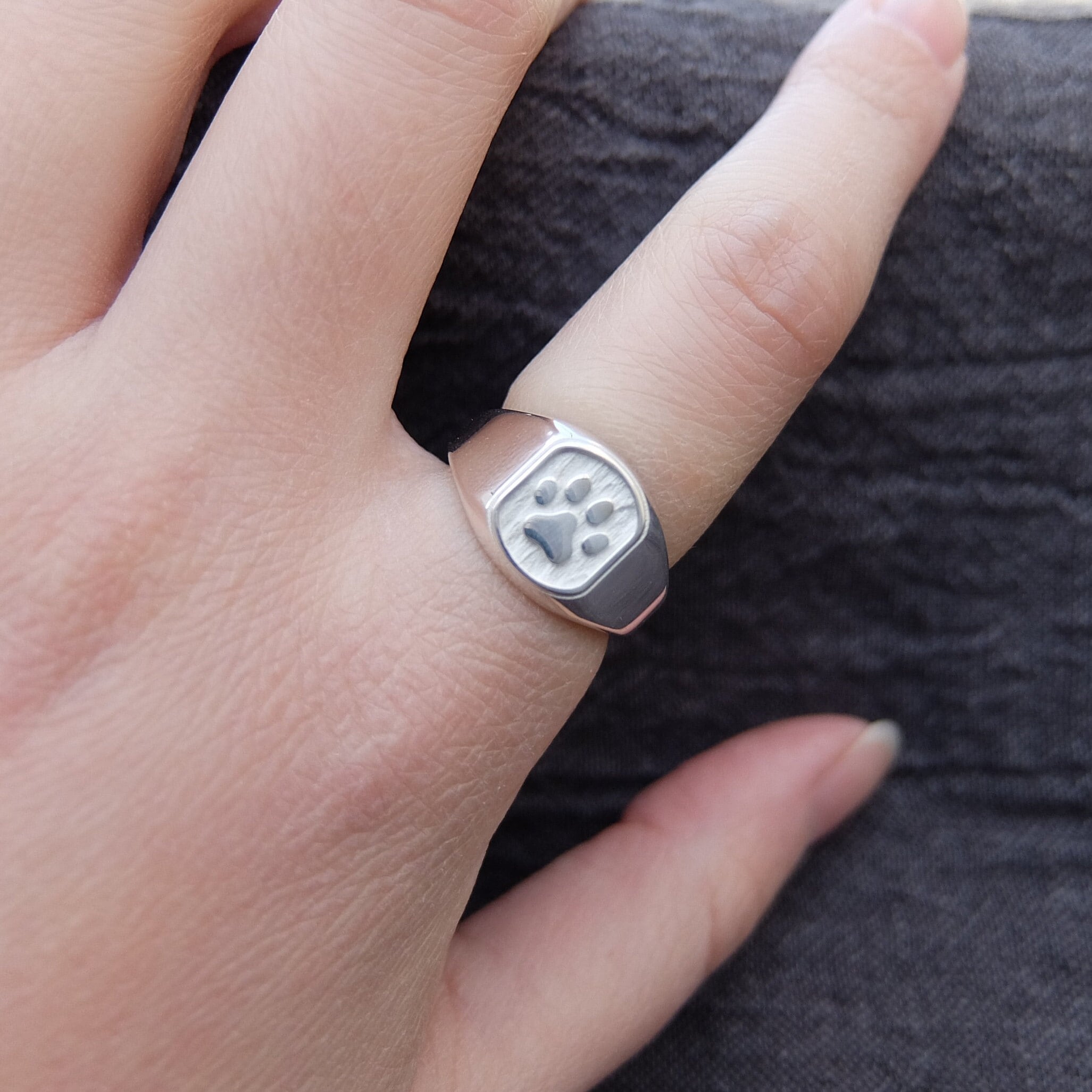 Handmade rainbow-colored stainless steel ring with paw print.