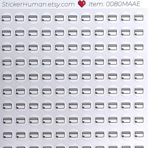 May include: Sheet of stickers featuring small, black and white credit card designs. Each sticker is a circle with a credit card graphic. The sheet has the text "StickerHuman.etsy.com" and "Item: 0080MAAE".