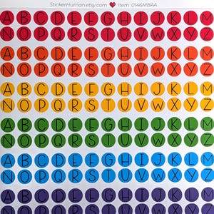 May include: Sheet of colorful alphabet stickers. Each sticker is a circle with a letter in black. The stickers are arranged in rows and columns, with each row a different color of the rainbow. The text "StickerHuman.etsy.com" is at the top.