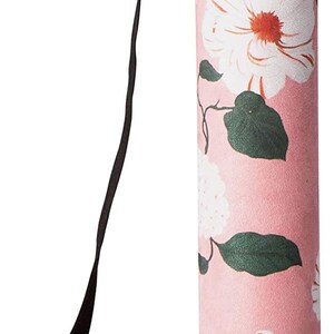 May include: A pink yoga mat with a floral print and a black carrying strap. The strap is adjustable and has a buckle closure.