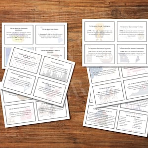 May include: Several white flashcards with black text on a wooden surface. The cards are arranged in stacks and include historical facts. The text on the cards includes topics such as the Monroe Doctrine and the Bill of Rights.