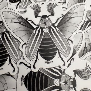 May include: A collection of black and white stickers featuring detailed illustrations of beetles. The stickers have a white border and include the text "buggy-inks". The beetles have striped abdomens and detailed wing patterns.