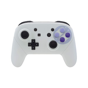 May include: A white Nintendo Switch controller with black buttons and a purple and white Super Nintendo style button layout.