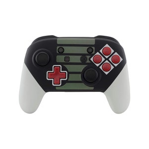 May include: A black and green Nintendo Switch controller with red buttons and a white grip. The controller has a retro design with a striped pattern.