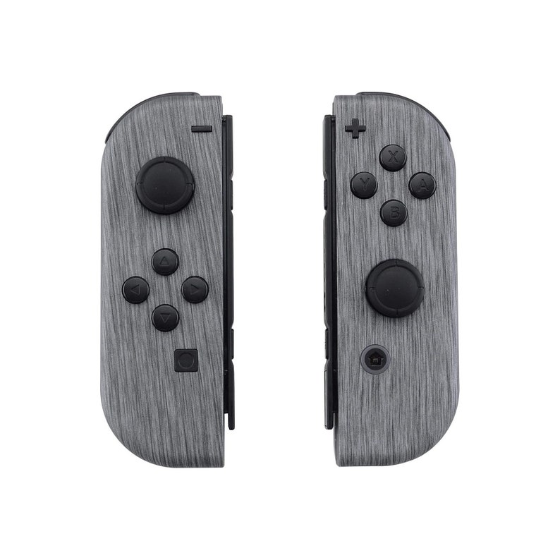 Może przedstawiać: Para kontroler&oacute;w Nintendo Switch Joy-Con w kolorze szarym i czarnym z wzorem imitującym drewno.