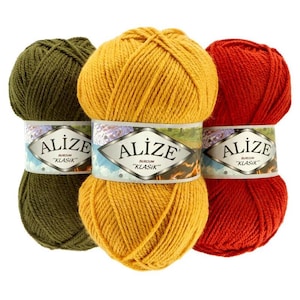 May include: Three skeins of Alize Klasik yarn in olive green, golden yellow, and red. Each skein is wrapped with a label featuring the brand name and product details. The yarn is tightly wound, suggesting it's suitable for knitting or crochet projects.
