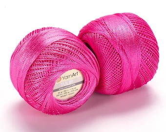 May include: Two balls of bright pink yarn, labeled "YarnArt TULIP" with details about the yarn weight, length, and yardage.