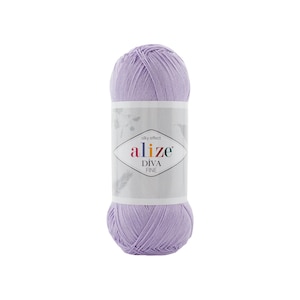 May include: A skein of light purple yarn with a silky effect. The center label features the text "silky effect alize DIVA FINE" inside a diamond-shaped border, accompanied by subtle illustrations of leaves and feathers on a white background.