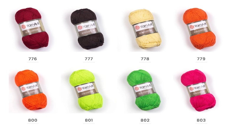 Peut inclure: Huit pelotes de fil YarnArt Eco Cotton dans diff&eacute;rentes couleurs, dont le rouge, le marron, le jaune, l'orange, le vert et le rose. Chaque pelote est &eacute;tiquet&eacute;e avec le nom de la marque et le num&eacute;ro de la couleur.
