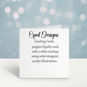 May include: White greeting card with black text that reads "Opal Designs Greeting Cards 300gsm Quality card, with a white envelope using artist designed, 300dpi illustrations"