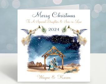 May include: A Christmas card with a nativity scene illustration. The card features the text "Merry Christmas To A Special Daughter & Son-in-Law 2024" in elegant script. The names "Wayne & Karen" are also printed on the card.