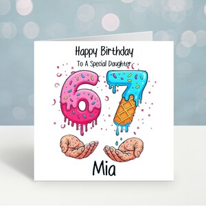 May include: A birthday card with the text "Happy Birthday To A Special Daughter". The number "6" is designed as a pink donut, and the number "7" is designed as a blue ice cream cone. The name "Mia" is written at the bottom.