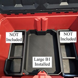 May include: Open red and black tool box with a black tray labeled "Large B1 Installed". Two black trays on either side are labeled "NOT Included".