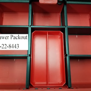 May include: A red and black 3-drawer Packout storage container. The container has a rectangular shape with multiple compartments and the text "3 Drawer Packout 48-22-8443" in a white box.