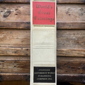 May include: A white book with a red spine titled "World's Great Paintings". The book has gold lettering and a black label on the bottom that reads "Standard Reference Works Publishing Company, Inc."