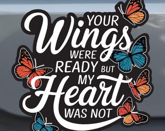May include: White text on a black background reads "Your Wings Were Ready But My Heart Was Not". The text is surrounded by colourful butterfly images.