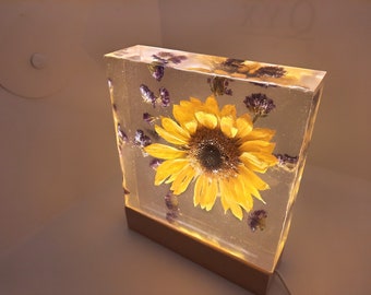 Real, Dried Resin Sunflower Block. Made with purple statice flowers! USB-corded wooden light pedestal (warm light) and wall plug included.