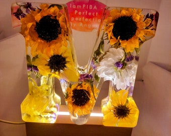 Real Sunflower Resin Letter Block. 6-Inch Real Sunflower Resin Block. Paperweight. Decor. Comes with a LED wood pedestal and USB Wall plug.