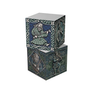 May include: Two stacked square boxes with a Celtic design. Each box features a different illustration of a man playing a musical instrument. The top box has a blue background and the bottom box has a green background.