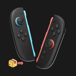 May include: Two black game controllers with blue and red accents. Each controller has a joystick, buttons, and a directional pad. The image includes a graphic of a box with the words "Mail In".
