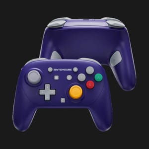 May include: A purple SwitchHouse controller with gray and colorful buttons. The controller has a plus-shaped directional pad, a yellow center button, and the text "SwitchHouse" above the buttons. The controller is designed for gaming.