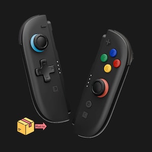 May include: Two black game controllers with colorful buttons and joysticks. One controller has a blue joystick and a directional pad. The other has a red joystick and colored buttons. The controllers are designed for gaming.