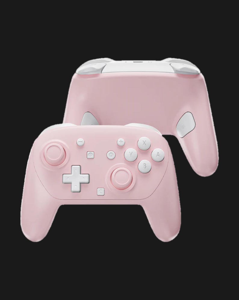 May include: A pink wireless game controller with white accents. The controller features a D-pad, face buttons, and analog sticks. The design includes a second controller in the background, showing the top and back.