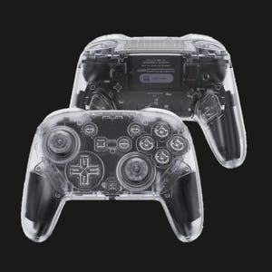 May include: Two transparent game controllers are displayed against a black background. The controllers show the internal components, including buttons, joysticks, and circuit boards. The design is sleek and modern, with a focus on the internal mechanics.