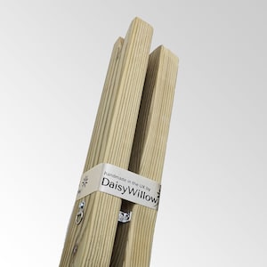 May include: A set of three wooden legs for a piece of furniture, with a label that reads "handmade in the UK by DaisyWillow".