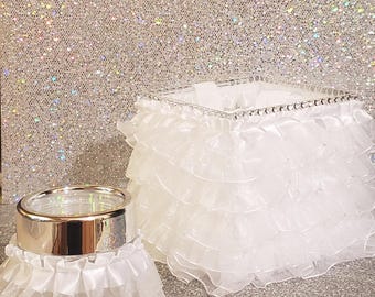 This is a beautiful small acrylic flower girl basket with white ruffle ribbon and matching ring bearer holder.