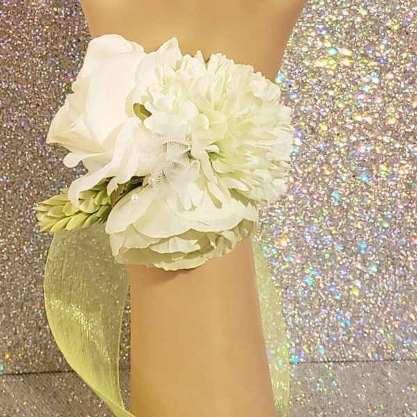 This is a corsage with lime green and white artificial flowers. Matching adjustable silver tone floral gem ring.