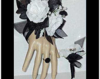 This is a beautiful corsage & boutonniere set with white artificial flowers which includes matching adjustable silver tone ring