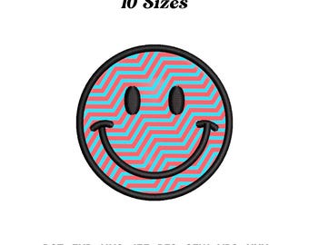 May include: A smiley face design with a black outline, featuring a zig-zag pattern in shades of red and blue. The text "10 Sizes" is above the smiley face. Below the smiley face are the file types: DST, EXP, HUS, JEF, PES, SEW, VP3, XXX.