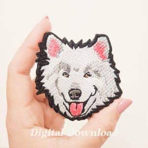 May include: Embroidered patch featuring a smiling wolf's head with gray fur, black outline, pink ears, and a red tongue. The patch has yellow eyes and the text "Digital Download" at the bottom.