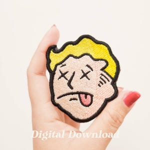 May include: Embroidered patch featuring a cartoon face with crossed-out eyes and a lolling tongue. The design has a yellow hairstyle, a black outline, and the text "Digital Download" at the bottom.