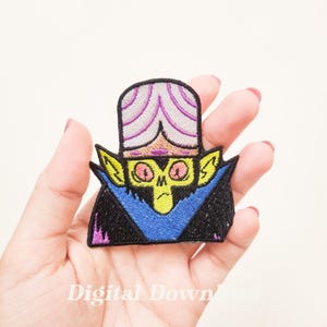 May include: An embroidered iron-on patch featuring a cartoon character with a purple and white hat, yellow skin, and a blue cape. The character has a grumpy expression and large eyes. The patch is perfect for adding a touch of whimsy to clothing, bags, or other accessories.