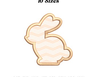 May include: A beige bunny-shaped design with a white chevron pattern filling. The outline is a darker beige. The text "10 Sizes" is above the bunny. Below the bunny are the file types: DST, EXP, HUS, JEF, PES, SEW, VP3, and XXX.