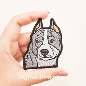 May include: Embroidered patch featuring a stylized dog head with gray and white fur, black outline, and yellow ear accents. The patch is held in a hand. The text "Digital Download" is at the bottom.