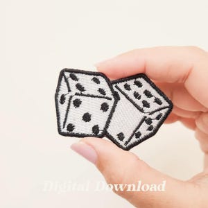 May include: A white and black embroidered patch of two dice, one on top of the other. The dice are white with black dots.