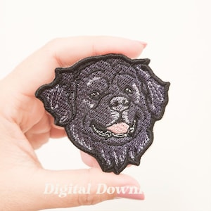 May include: Embroidered patch featuring a smiling black dog's face with a pink tongue. The patch has a detailed design with a dark purple outline and the text "Digital Down" at the bottom.