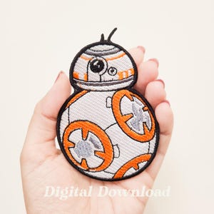 May include: An embroidered iron-on patch featuring a white and orange cartoon robot with a black outline. The robot has a round body with a dome-shaped head and a single antenna. The robot's eyes are black and its mouth is a small black line.