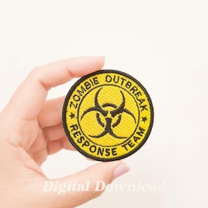 Puede incluir: Parche bordado amarillo y negro con un símbolo de riesgo biológico y el texto "Zombie Outbreak Response Team".